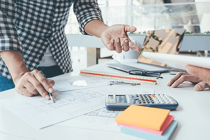 Papers, Pencils, and calculator on a table